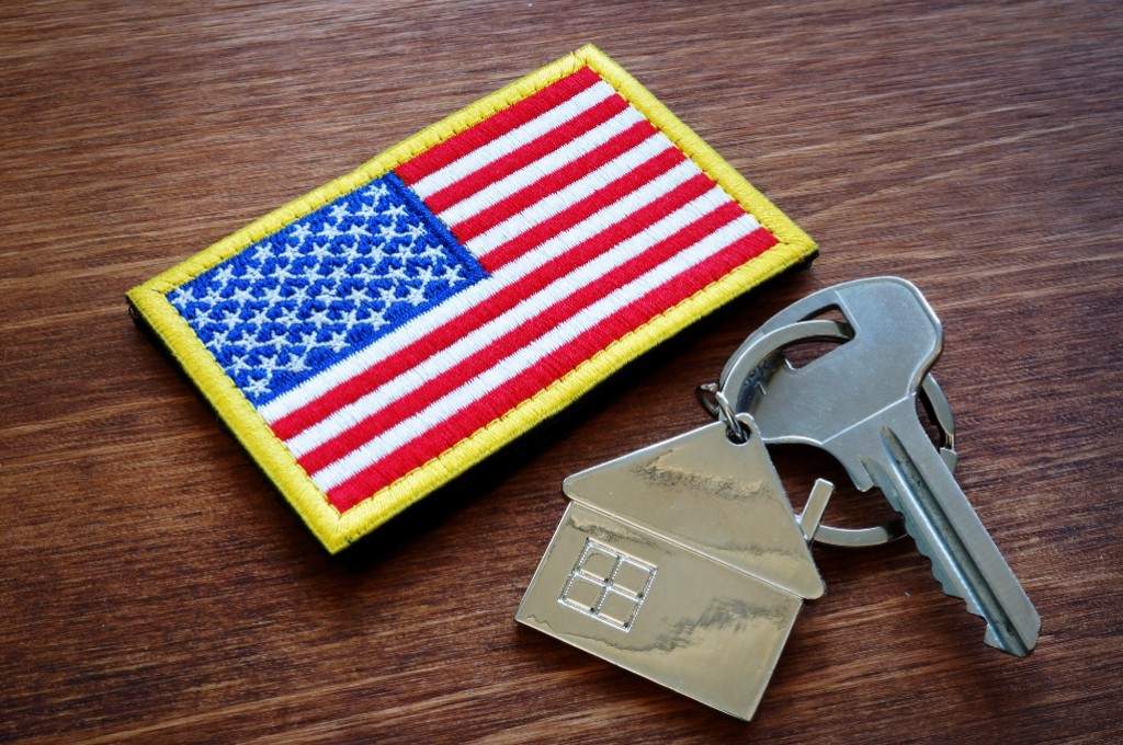 Keys on a table next to an American flag